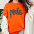 Pirates Sequin Patch, close-up of a woman's orange t-shirt with the word 'pirates' in black sequins, casual style with white cardigan.