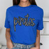 Pirates Sequin Patch, image of a blue t-shirt with a sparkly sequin pirate-themed patch design.