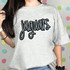 Jaguars Sequin Patch, a close-up of a grey t-shirt with a large, sparkling sequin patch spelling 'jaguars' in stylized cursive font on the front.