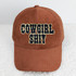 Cowgirl Shit Embroidered Glitter Hat/Pocket Embroidered Patch, a brown corduroy baseball cap with the phrase 'Cowgirl Shit' embroidered in black with glittery border on the front.