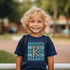 Kindergarten Checker DTF Heat Transfer, image of a young boy wearing a t-shirt with the letter 'K' design made of checkerboard pattern for kindergarten.