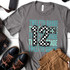 Twelfth Grade Checker DTF Heat Transfer, a gray T-shirt with a large checkered number 12 and repeating 'Twelfth Grade' text in blue and light blue.