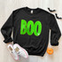 Neon Green BOO Sequin Patch, Halloween themed sweatshirt with bold green sequined 'BOO' lettering on black fabric.