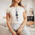 Moons DTF Heat Transfer, a design featuring moon phases and stars printed on a white T-shirt.