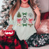 Christmas Vacation Coquette DTF Heat Transfer, a festive holiday design featuring Christmas trees, bows, a camper, a reindeer, and the phrase 'You serious Clark?' on a woman's t-shirt.