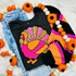 Pink Sequin Turkey Patch, colorful felt turkey patch with sequins on black fabric, paired with blue denim jeans and a black, orange, pink, and purple striped sweater, decorated with a pumpkin garland.