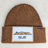 Fox Off Embroidered HAT/POCKET Patch, brown knit beanie with an embroidered patch of a lying fox and the text 'FOX OFF' underneath.