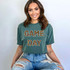 Game Day ADULT Screen Print Transfer, woman wearing a green t-shirt with leopard print 'Game Day' text for sports fans.