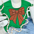 Sequins Basketball Bow Patch, orange glittery bow embroidery on a green T-shirt