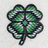 Four Leaf Clover Embroidered HAT/POCKET Patch, green and white four-leaf clover design embroidered on black outlined patch.