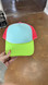 Green Billed Tricolor Foam Trucker Hat, vibrant color block design with green, blue, and red accents with mesh back panels.