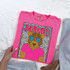Jaguars Colorful Mascot DTF Heat Transfer, pink T-shirt featuring a cartoon jaguar mascot with star-shaped sunglasses and vibrant design.