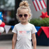 God Bless America Bows DTF Heat Transfer, white t-shirt with patriotic bow design in red, blue, and pink for kids.