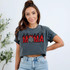 Mama Flames DTF Heat Transfer, woman wearing a gray cropped t-shirt with a Mama Flames DTF heat transfer design featuring a flaming 'MOMA' text with a checkered heart in the middle.
