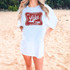 It's Lake Time RED DTF Heat Transfer, a red distressed graphic with the text 'It's Lake Time' printed on a white t-shirt worn by a woman on the beach.