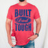 Built Dad Tough DTF Heat Transfer, a graphic design on a red T-shirt featuring bold blue text and a distressed finish.