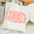 Summer Retro Flowers DTF Heat Transfer, vibrant pink and yellow floral pattern spelling 'SWEET' on a beige tote bag.