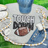 Touchdown with Football Sequins Patch, casual outfit flat lay with a grey sweatshirt, blue jeans, white sneakers, a denim cap, a beaded necklace, and socks on a green background.