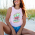 Salty Flamingo Palm Trees DTF Heat Transfer, colorful flamingo and palm tree design on a sleeveless pink top worn by a woman sitting on the beach.