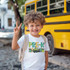 Back To School Monster Truck DTF Heat Transfer, a young boy smiling and making a peace sign while standing in front of a yellow school bus."