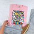 Dotted Graffiti Mascot DTF Heat Transfer, colorful cartoon hornet mascot with star-shaped eyes on a pink T-shirt.
