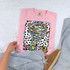 Dotted Graffiti Mascot DTF Heat Transfer, colorful design of a tornado on a pink T-shirt with black and white leopard print background.