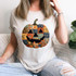 Patchwork Pumpkin DTF Heat Transfer, Halloween pumpkin design on white t-shirt worn by a woman.