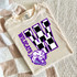 Checkered Mascot N-Z DTF Heat Transfer, sports team logo on a beige t-shirt featuring a black and white checkered letter with a fierce lion mascot and purple text.