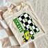 Checkered Mascot N-Z DTF Heat Transfer, a colorful design of a checkered number 8 with a cartoon mascot dressed as a banana runner, on a white T-shirt.