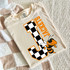 Checkered Mascot A-M DTF Heat Transfer, orange and black bee mascot with checkered pattern letter J on a beige T-shirt.