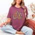 Give Thanks Cross DTF Heat Transfer, colorful and festive design on a woman wearing a maroon t-shirt.
