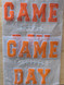 Game Day with Silicone Laces Patch - 10 Colors, orange felt letter patches spelling 'GAME DAY' with white backing and decorative stitching, packaged in a clear plastic bag.