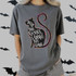 Twist The Bones & Bend The Back DTF Heat Transfer, Halloween-themed T-shirt design with a black cat silhouette and colorful outline on a gray T-shirt