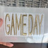 GAME DAY Puff Embroidered Hat with Pouch Patch in Various Colors, gold embroidered 'GAME DAY' patch on a white background.