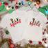 Elf Squad Glitter Effect Christmas Sublimation Transfer, showcasing two white T-shirts with festive Elf Squad designs amid Christmas decorations and lights.