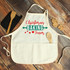 Christmas Baking Team Sublimation Transfer product, apron with Christmas baking design and text, on rustic wooden surface with cookies and baking tools.