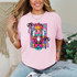Colorful Nutcracker DTF Heat Transfer, vibrant and detailed humorous nutcracker graphic on a pink T-shirt.