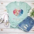 In A World Where You Can Be Anything Be Kind Screen Print Heat Transfer, T-shirt with colorful world map in the shape of a heart and positive message.