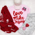 Love Like Jesus Red Fluffy Valentine's Day Patch, pink shirt with red text, red knitted cardigan, pink cap with 'SAVED' embroidered, pink and heart-shaped earrings, camouflage shorts, and decorative hearts for Valentine's Day.
