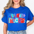 Reading Rocks DTF Heat Transfer, colorful patriotic-themed printed design on a blue t-shirt.