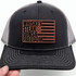 Whiskey, Steak, Guns & Freedom Leather Hat Patch on a trucker cap with grey mesh and black front, featuring a patriotic American flag design.