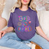 God Is Good Crayon DTF Heat Transfer, colorful hand-drawn style design on a purple T-shirt.