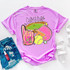 Bright Game Day DTF Heat Transfer, colorful graphic on pink T-shirt featuring sports equipment and the phrase 'Game Day'.