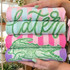 Preppy Later Gator DTF Heat Transfer, colorful folded towels featuring green and pink crocodile and handwritten-style lettering designs.