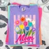Flower Bouquet Title DTF Heat Transfer, colorful floral design with the word 'Mom' on a purple fabric T-shirt.