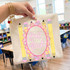 Coquette Grade School DTF Heat Transfer, educational and decorative heat transfer design with pencils and the words 'first grade' on a fabric school bag.