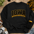 Iowa inspired chenille patch iron on varsity football patch for sweatshirts featuring black and gold collegiate lettering with football stitch accents.