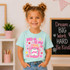 Is My Jam Back to School DTF Heat Transfer | Grades Pre-K–4, young girl wearing a mint green t-shirt with a pink jam jar design and the phrase 'Pre-K is My Jam' in a classroom setting.