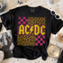 Retro Band Tees - Knockout Black DTF Heat Transfer, black T-shirt featuring bright yellow and pink 'AC/DC' logo with leopard and checkered patterns.