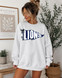 Pennant Teams DTF Heat Transfer, Navy blue and white graphic pennant with the word 'LIONS' on a woman's sweatshirt.